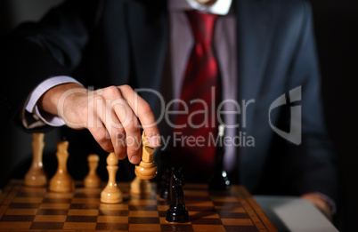 Businessman playing chess