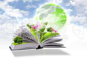 Open book with green nature world