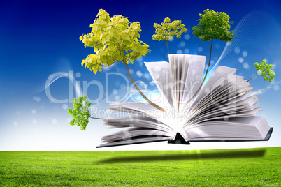 Open book with green nature world