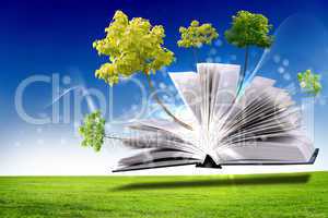 Open book with green nature world