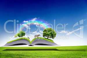 Open book with green nature world