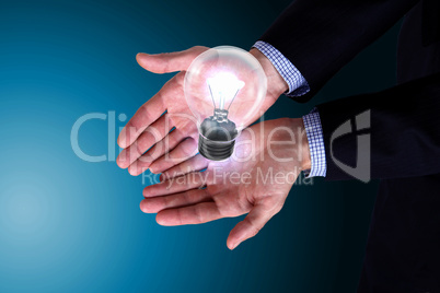 Human hand holding electric bulb