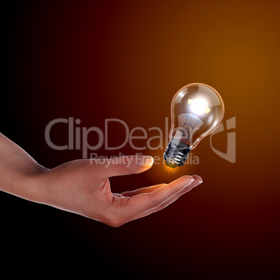 Human hand holding electric bulb