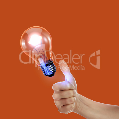 Human hand holding electric bulb
