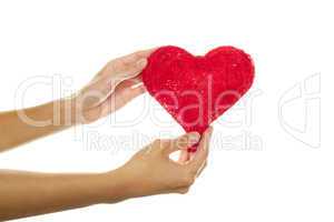 Female hands holding a red heart