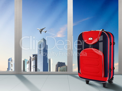 Red suitcase and plane