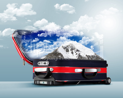 Red suitcase with snowy mountains inside