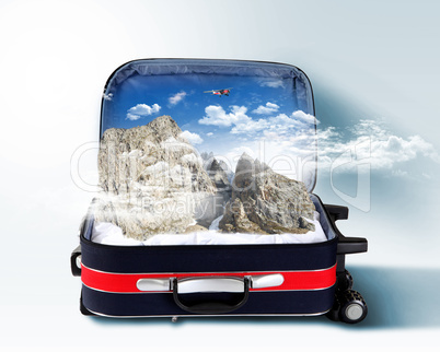 Red suitcase with snowy mountains inside