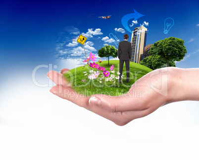 human hand holding a green city