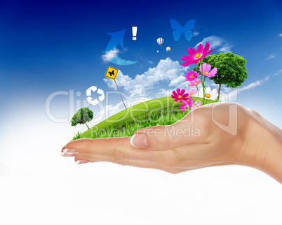 human hand holding a green city