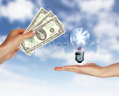 Human hands with money and electric bulb