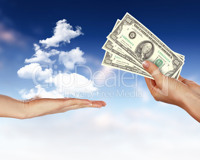 Human hands holding money against blue sky