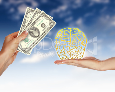 Human hands holding money against blue sky