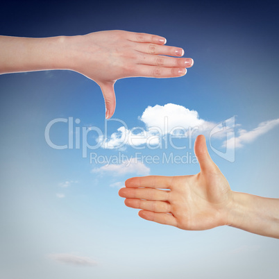 Hands and blue cloudy sky