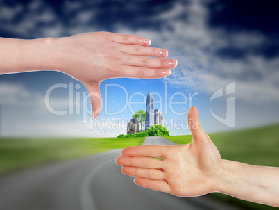 Human hands and house against blue sky