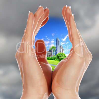 Human hands and house against blue sky