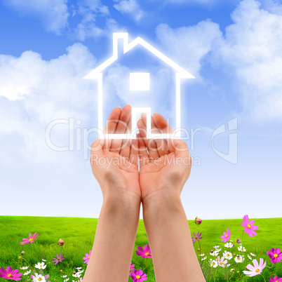 hands holding house