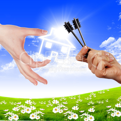 hands holding house