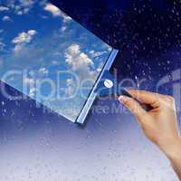 Window with blue sky and white clouds