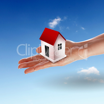 House from white clouds against blue sky