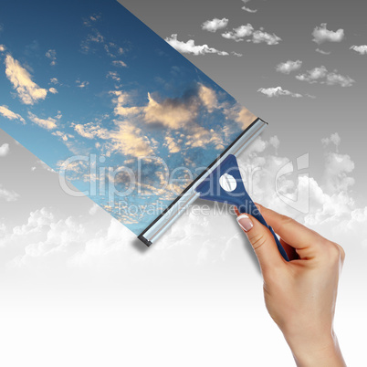 Window with blue sky and white clouds