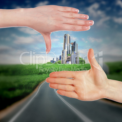 Human hands and house against blue sky