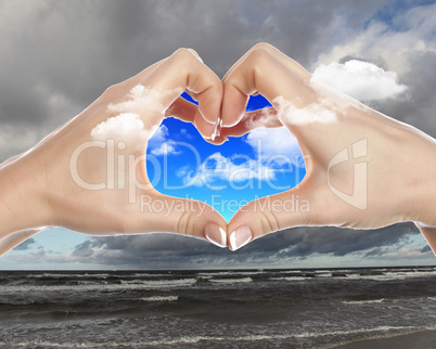 Hands and blue cloudy sky