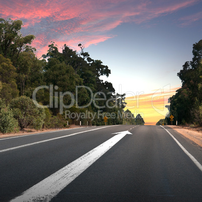Empty countryside road with white arrow