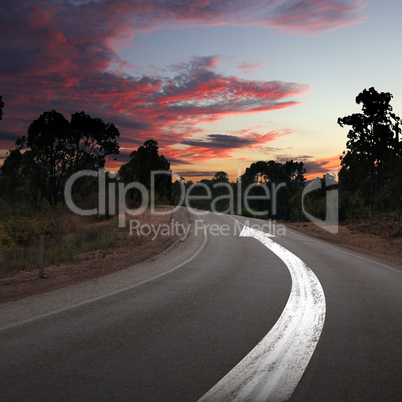 Empty countryside road with white arrow