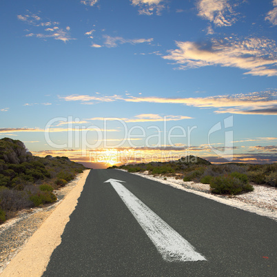 Empty countryside road with white arrow