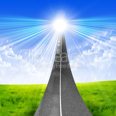 road stretches into a bright blue sky