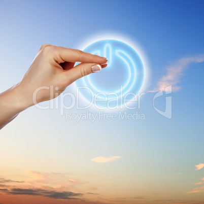 Power button against sky background