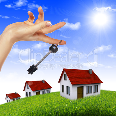 House in the hands against the blue sky