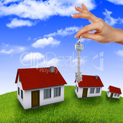 House in the hands against the blue sky