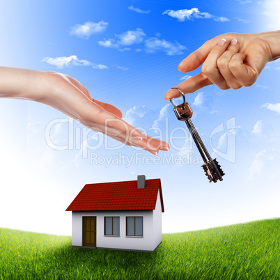 House in the hands against the blue sky