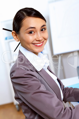 Young woman in business wear working in office