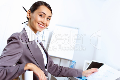 Young woman in business wear working in office