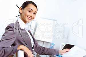 Young woman in business wear working in office