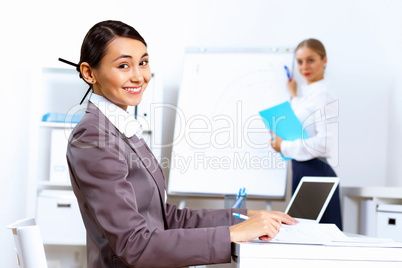 Young woman in business wear working in office