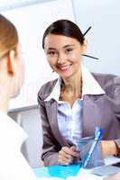 Young women in business wear working in office