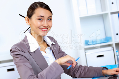 Young woman in business wear working in office