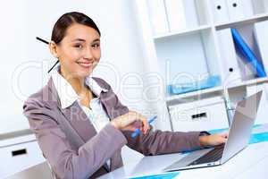 Young woman in business wear working in office