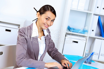 Young woman in business wear working in office