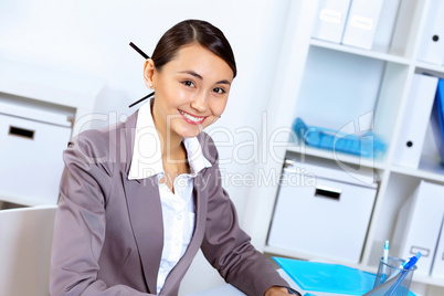 Young woman in business wear working in office