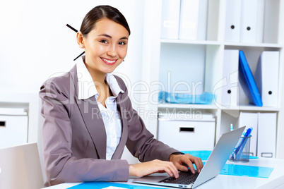 Young woman in business wear working in office