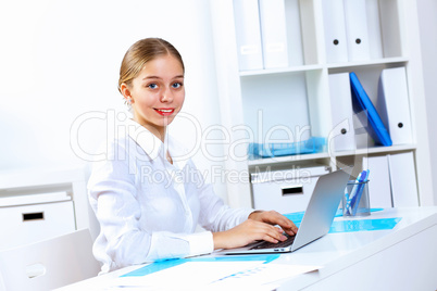 Young woman in business wear working in office