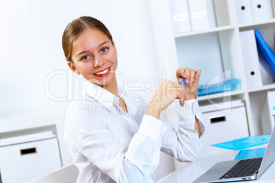 Young woman in business wear working in office