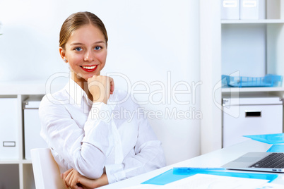 Young woman in business wear working in office