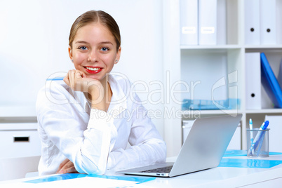 Young woman in business wear working in office