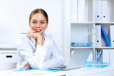 Young woman in business wear working in office